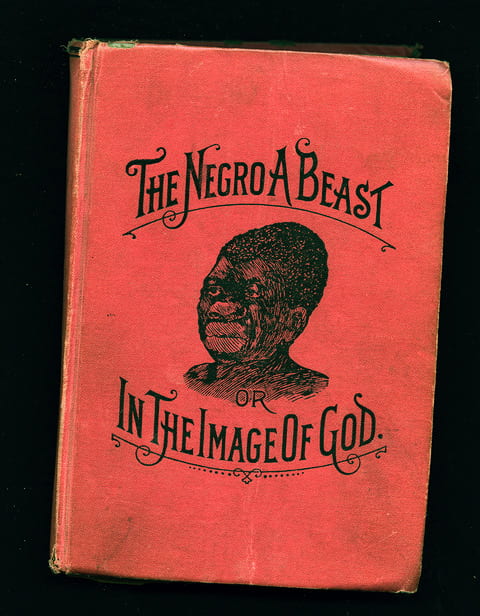 An old illustration of an African American man on the red cover of a book